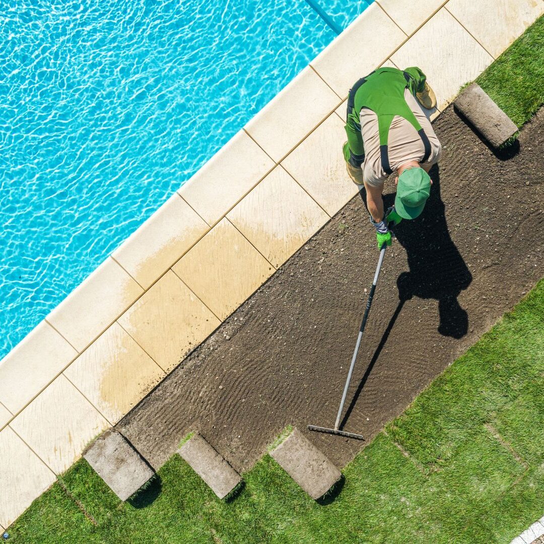 Landscaper Installing Brand New Grass Turfs around Pool Landscaper Installing Brand New Grass Turfs around Pool